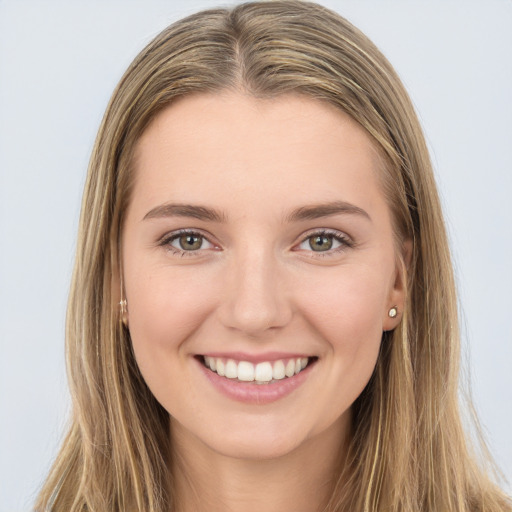 Joyful white young-adult female with long  brown hair and green eyes