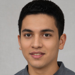 Joyful white young-adult male with short  black hair and brown eyes