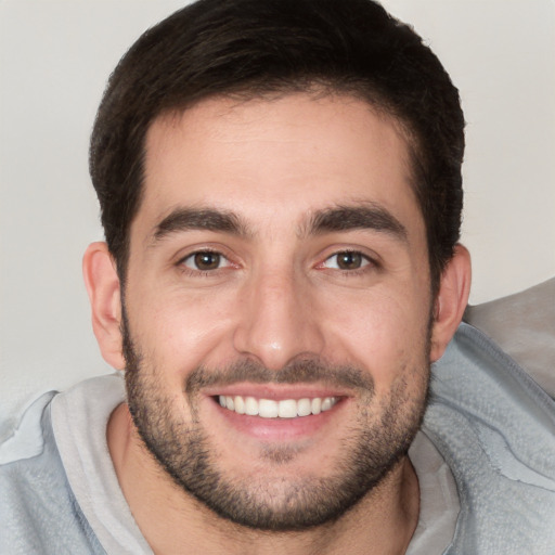 Joyful white young-adult male with short  black hair and brown eyes