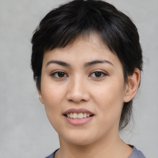 Joyful asian young-adult female with medium  black hair and brown eyes