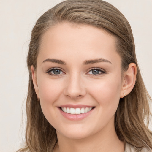 Joyful white young-adult female with long  brown hair and grey eyes