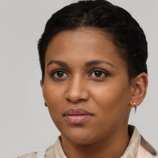 Joyful black young-adult female with short  brown hair and brown eyes