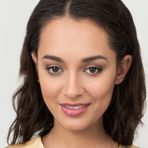 Joyful white young-adult female with long  brown hair and brown eyes