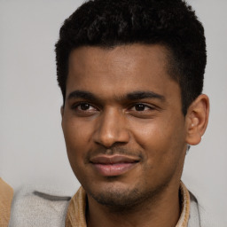 Joyful black young-adult male with short  black hair and brown eyes