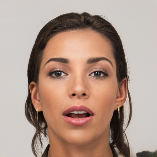 Joyful white young-adult female with long  brown hair and brown eyes