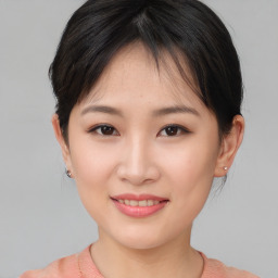 Joyful asian young-adult female with short  brown hair and brown eyes