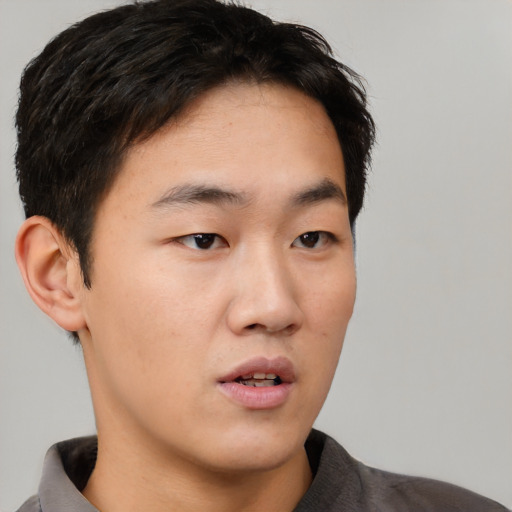 Neutral asian young-adult male with short  brown hair and brown eyes