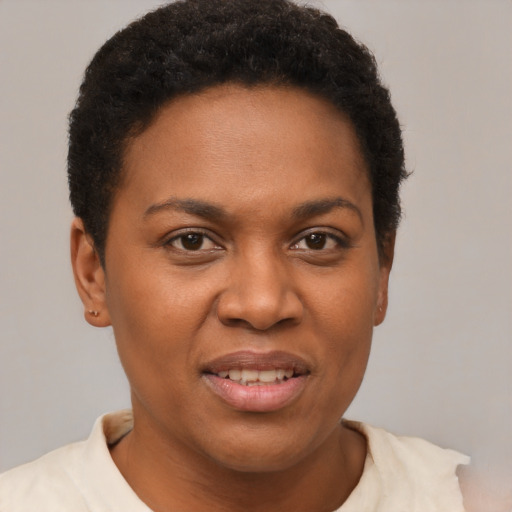 Joyful black young-adult female with short  brown hair and brown eyes