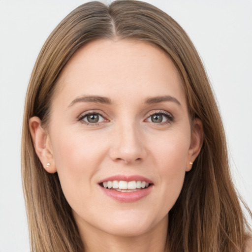 Joyful white young-adult female with long  brown hair and grey eyes