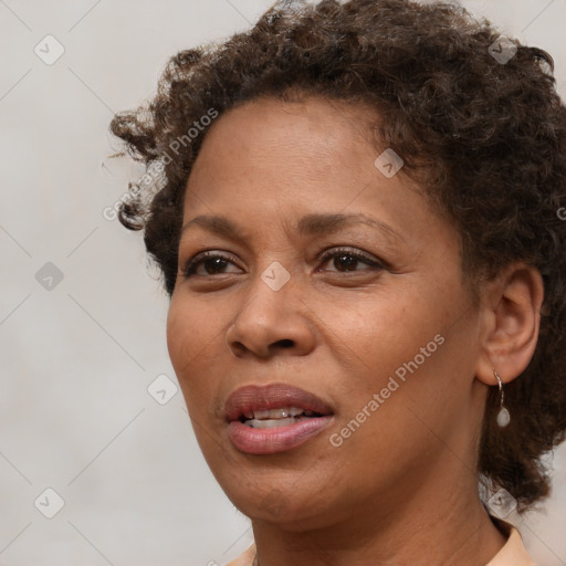 Joyful black adult female with short  brown hair and brown eyes