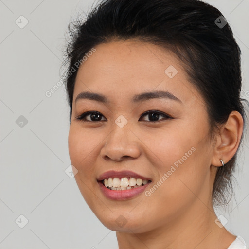 Joyful asian young-adult female with medium  black hair and brown eyes