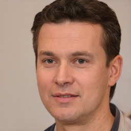 Joyful white adult male with short  brown hair and brown eyes