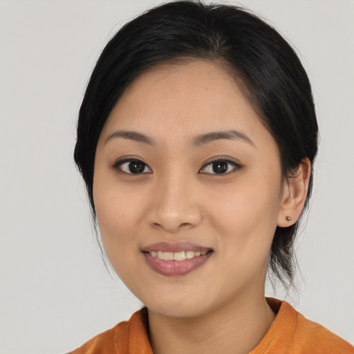 Joyful asian young-adult female with long  black hair and brown eyes