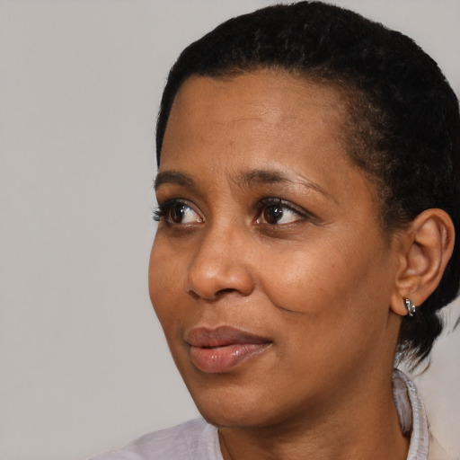 Joyful black adult female with short  black hair and brown eyes