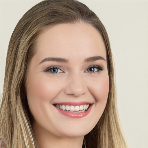 Joyful white young-adult female with long  brown hair and green eyes