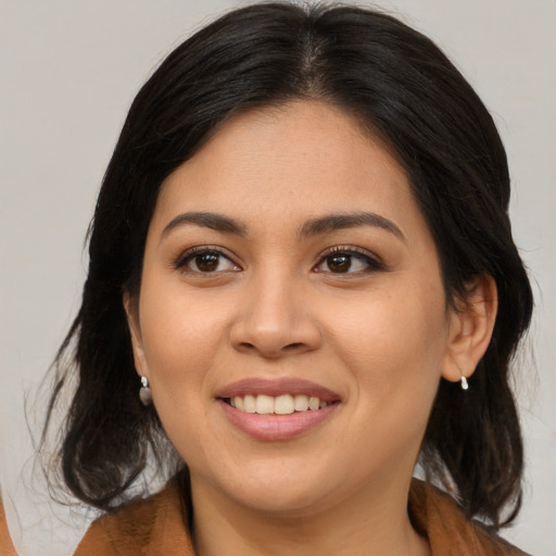Joyful asian young-adult female with medium  brown hair and brown eyes
