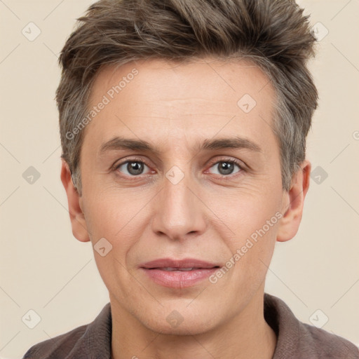 Joyful white adult male with short  brown hair and grey eyes