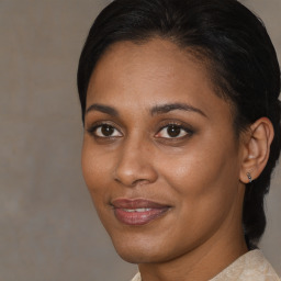 Joyful black young-adult female with medium  brown hair and brown eyes