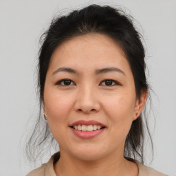 Joyful asian young-adult female with medium  brown hair and brown eyes