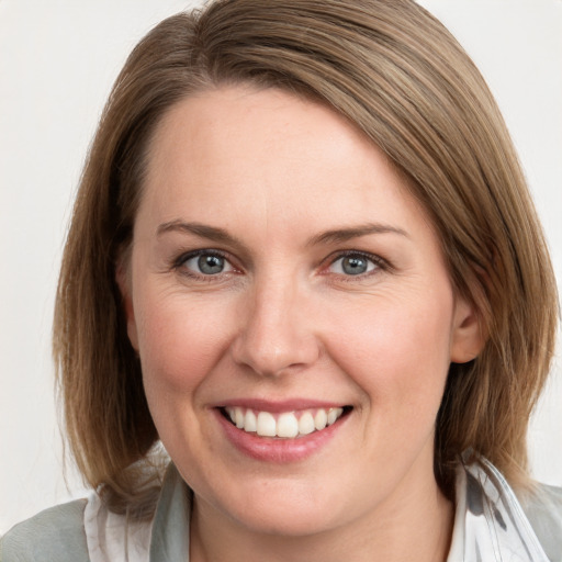 Joyful white young-adult female with medium  brown hair and blue eyes