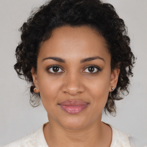 Joyful black young-adult female with medium  brown hair and brown eyes