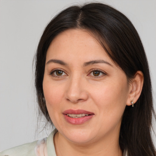 Joyful white adult female with long  brown hair and brown eyes