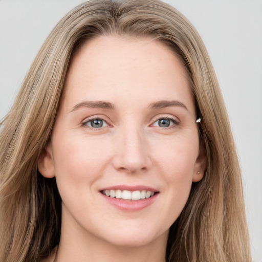 Joyful white young-adult female with long  brown hair and grey eyes