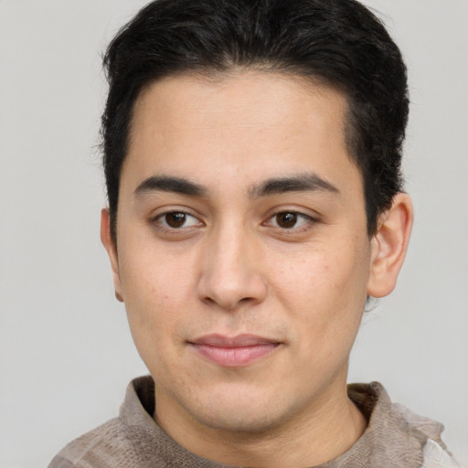 Joyful latino young-adult male with short  brown hair and brown eyes