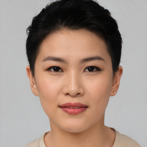 Joyful asian young-adult female with short  brown hair and brown eyes