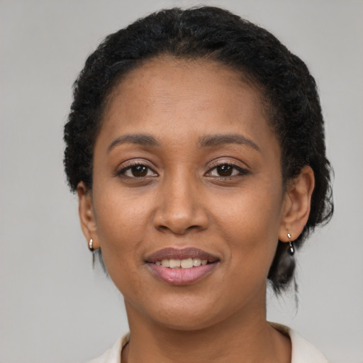 Joyful latino adult female with short  black hair and brown eyes