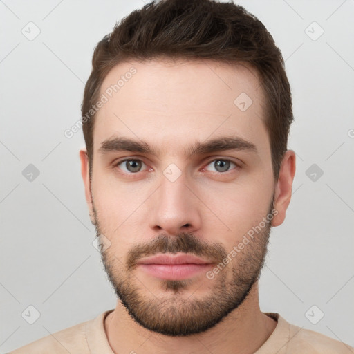 Neutral white young-adult male with short  brown hair and grey eyes