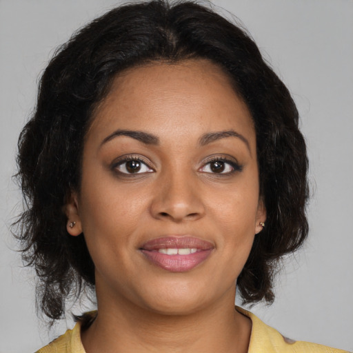 Joyful black young-adult female with medium  brown hair and brown eyes