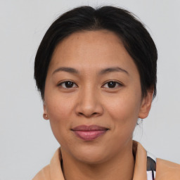 Joyful asian adult female with medium  brown hair and brown eyes