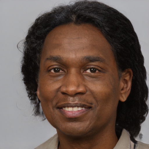 Joyful black adult male with medium  black hair and brown eyes