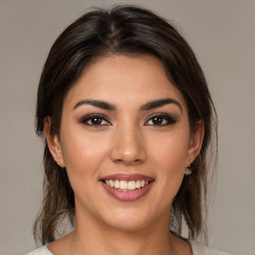 Joyful white young-adult female with medium  brown hair and brown eyes