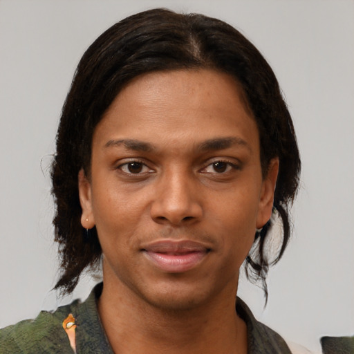 Joyful black young-adult female with medium  brown hair and brown eyes