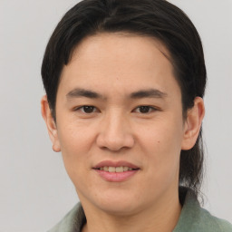 Joyful asian young-adult male with short  brown hair and brown eyes