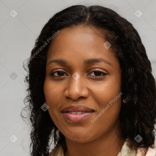 Joyful black young-adult female with long  brown hair and brown eyes