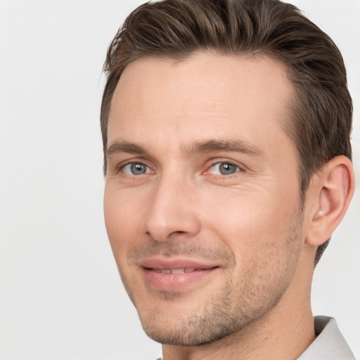 Joyful white adult male with short  brown hair and brown eyes