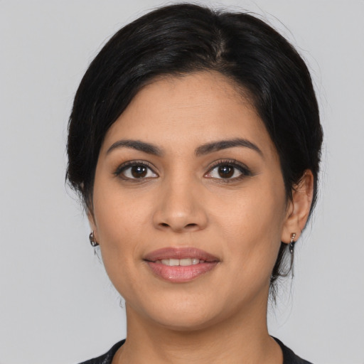 Joyful latino young-adult female with medium  black hair and brown eyes