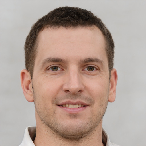 Joyful white young-adult male with short  brown hair and brown eyes