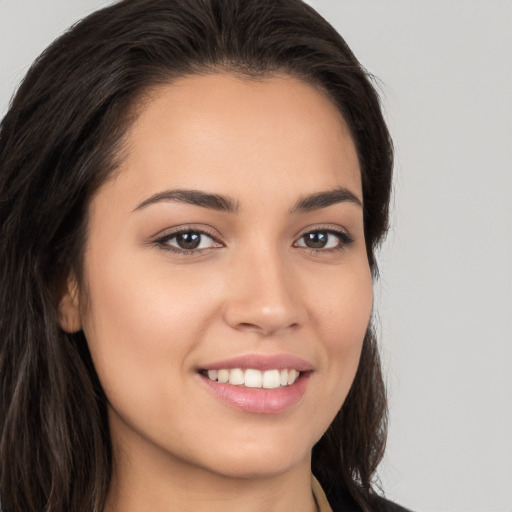 Joyful white young-adult female with long  brown hair and brown eyes