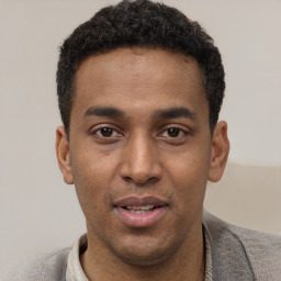 Joyful latino young-adult male with short  black hair and brown eyes