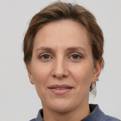 Joyful white adult female with medium  brown hair and grey eyes