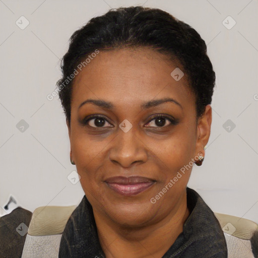 Joyful black adult female with short  black hair and brown eyes