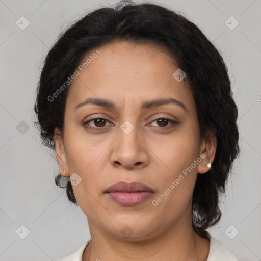 Joyful latino adult female with medium  brown hair and brown eyes