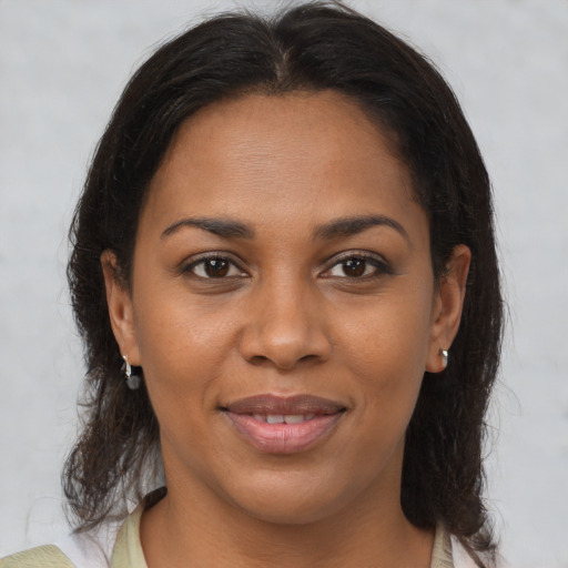 Joyful black young-adult female with medium  brown hair and brown eyes