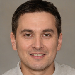 Joyful white young-adult male with short  brown hair and brown eyes