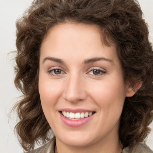 Joyful white young-adult female with medium  brown hair and green eyes