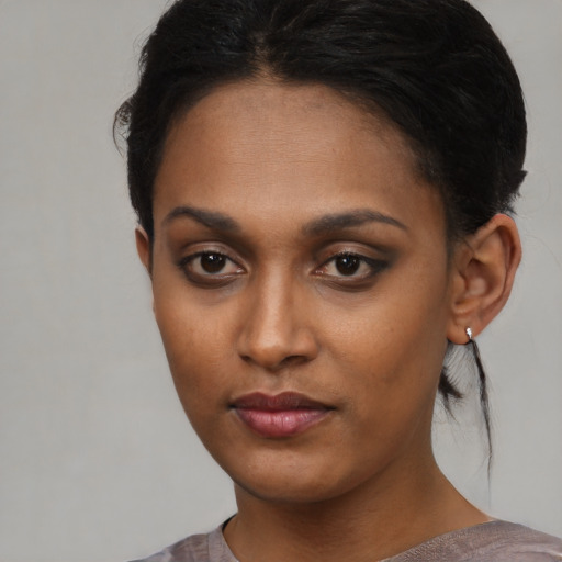 Neutral black young-adult female with short  brown hair and brown eyes